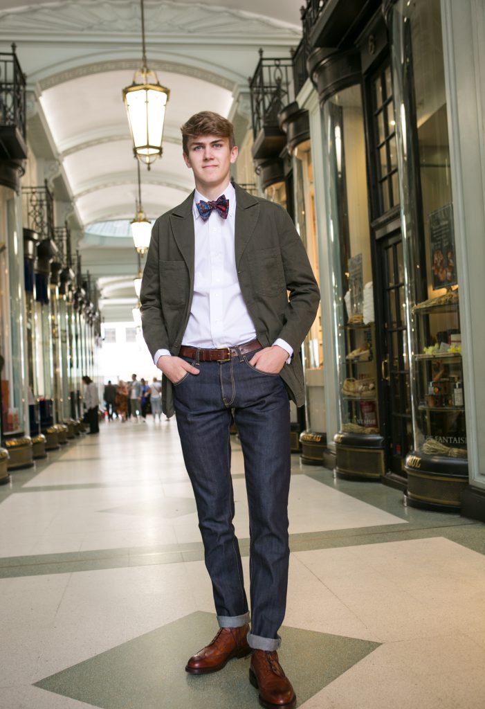 Fin Tusting models a slim fit shirt and paisley bow tie by Budd Shirtmakers, jeans by Forge Denim and blazer by Realm and Empire. Shoes are Skye brogue boots from Crockett and Jones